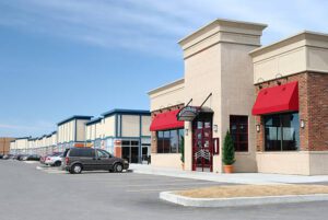Exterior of a restaurant with beige walls and red awnings in Richmond, VA