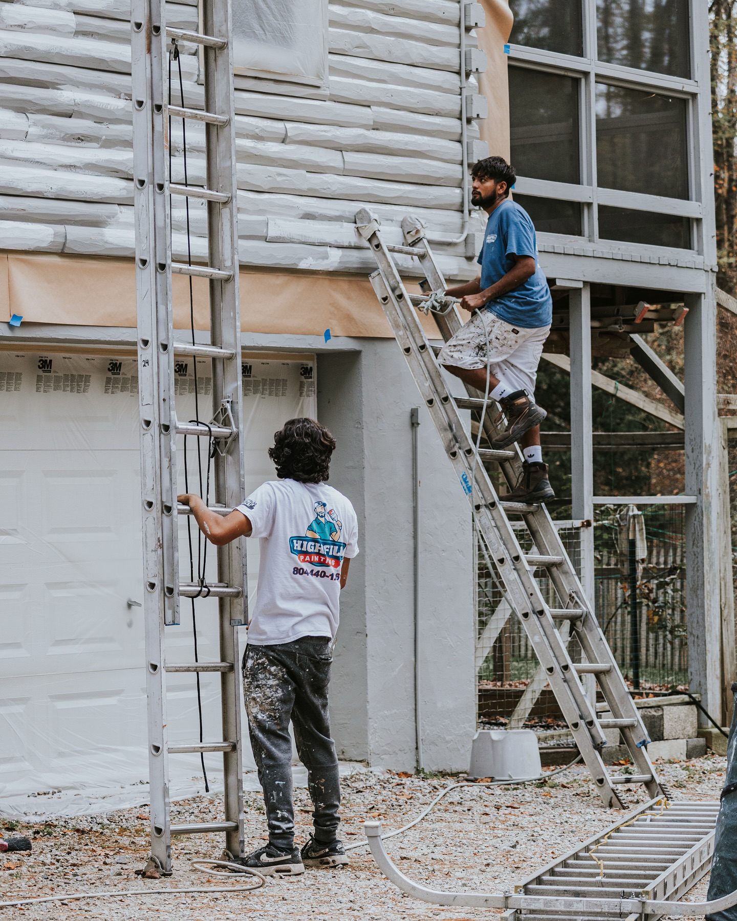 Highfill worker painting the outside of a home in Richmond, VA.