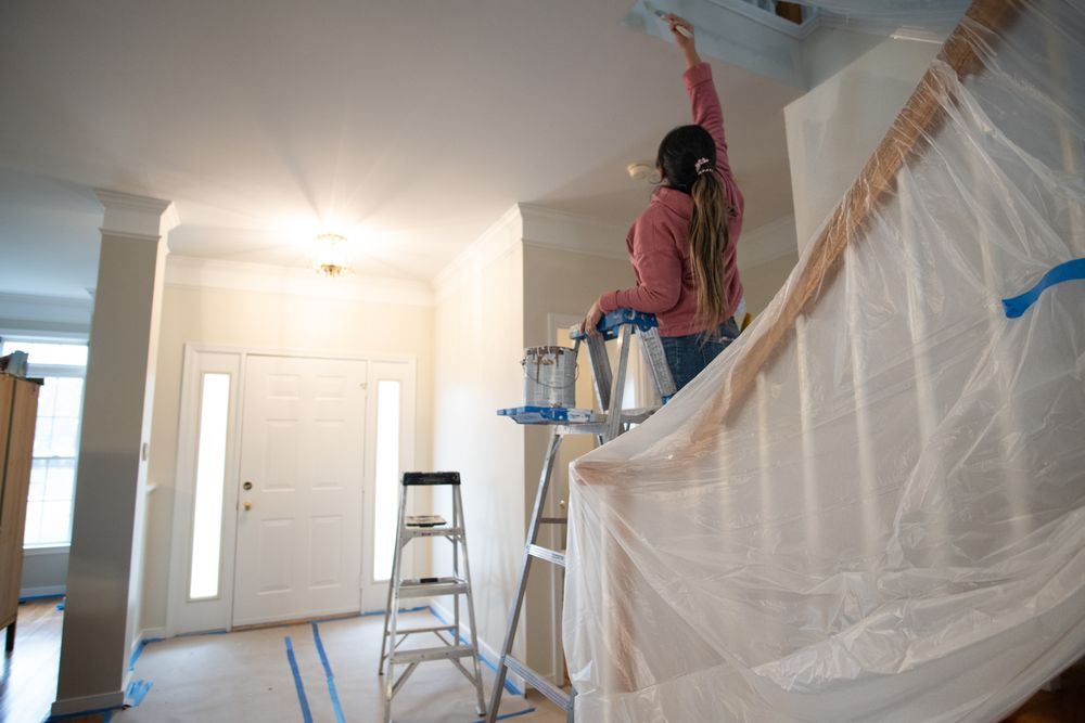 Worker painting interior of Richmond home.